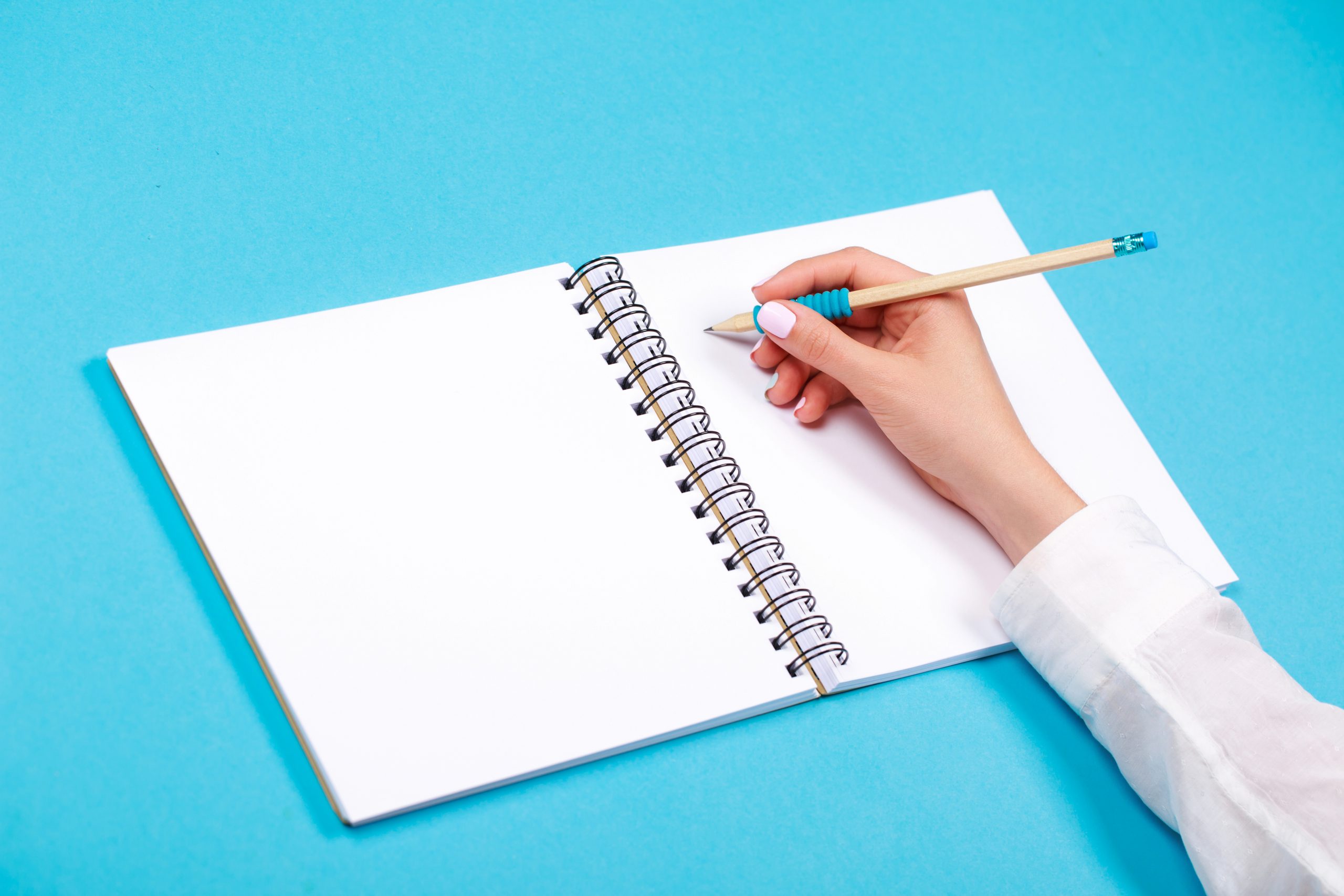 Spiral notepad with pencil as mockup for design